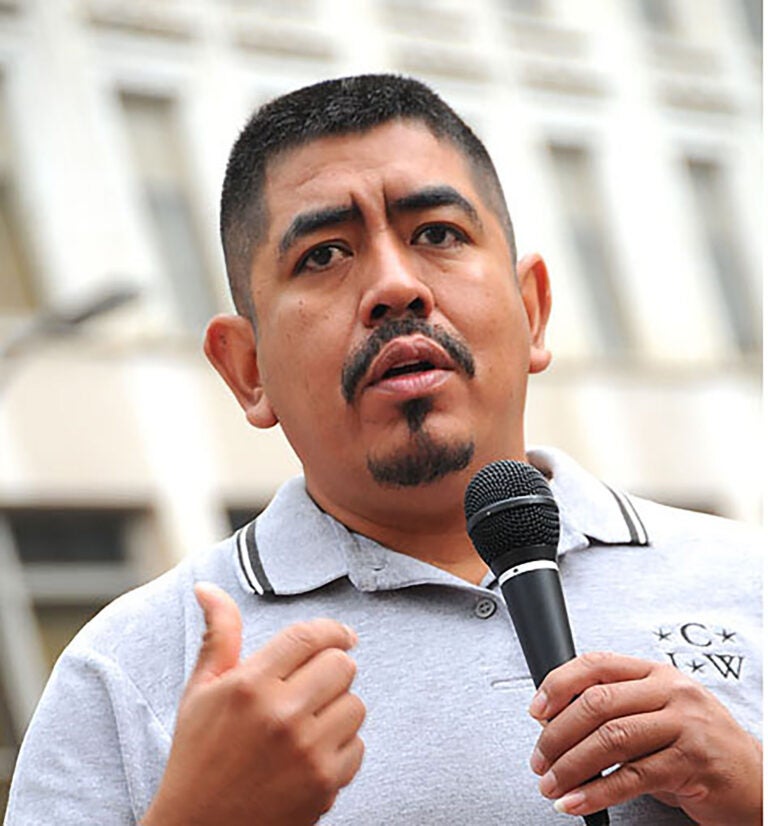 Photo of Lucas Benitez speaking into a microphone